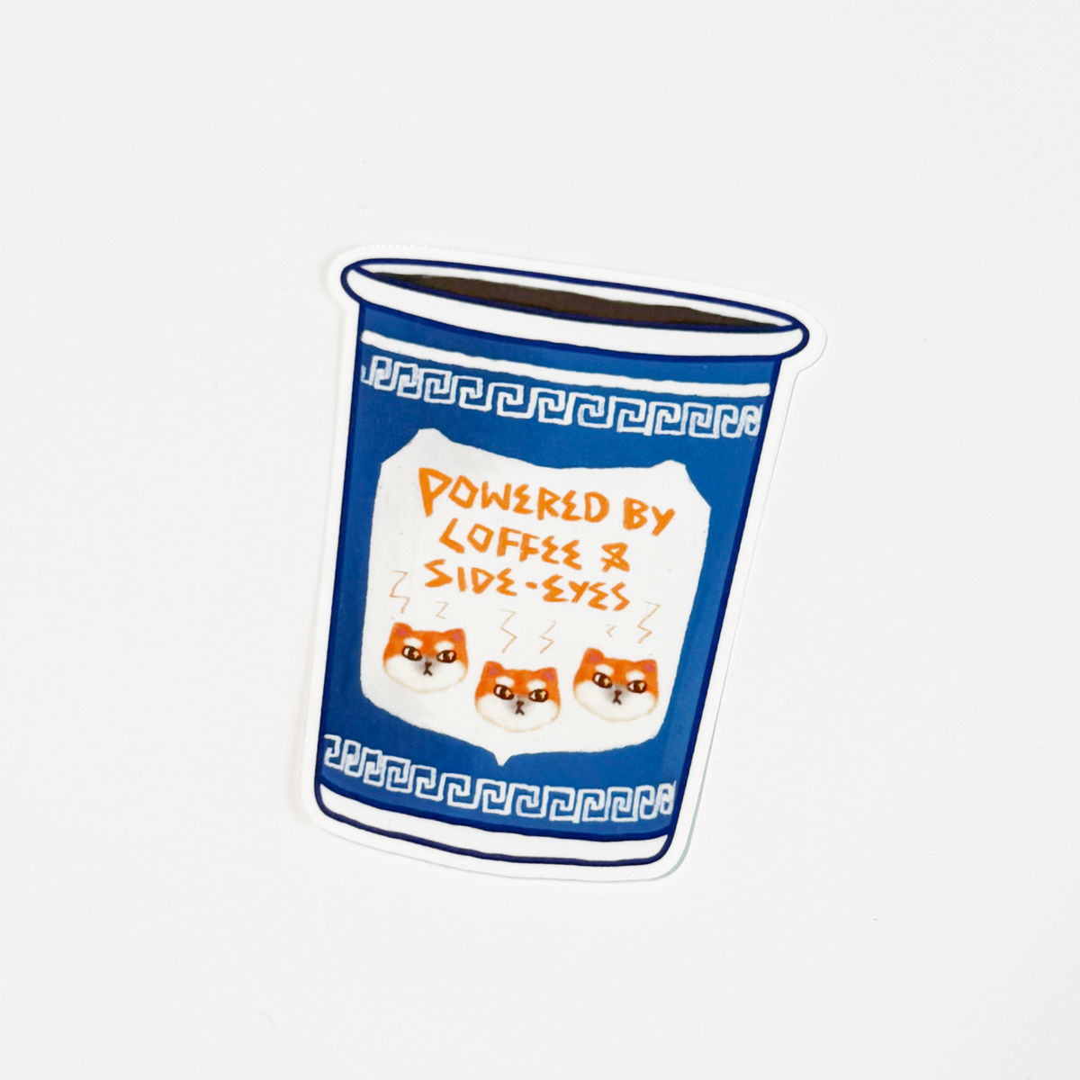 A die-cut sticker depicting a blue coffee cup with Greek key patterns and three orange cartoon dog faces, featuring the text 'POWERED BY COFFEE & SIDE-EYES' on a white background.