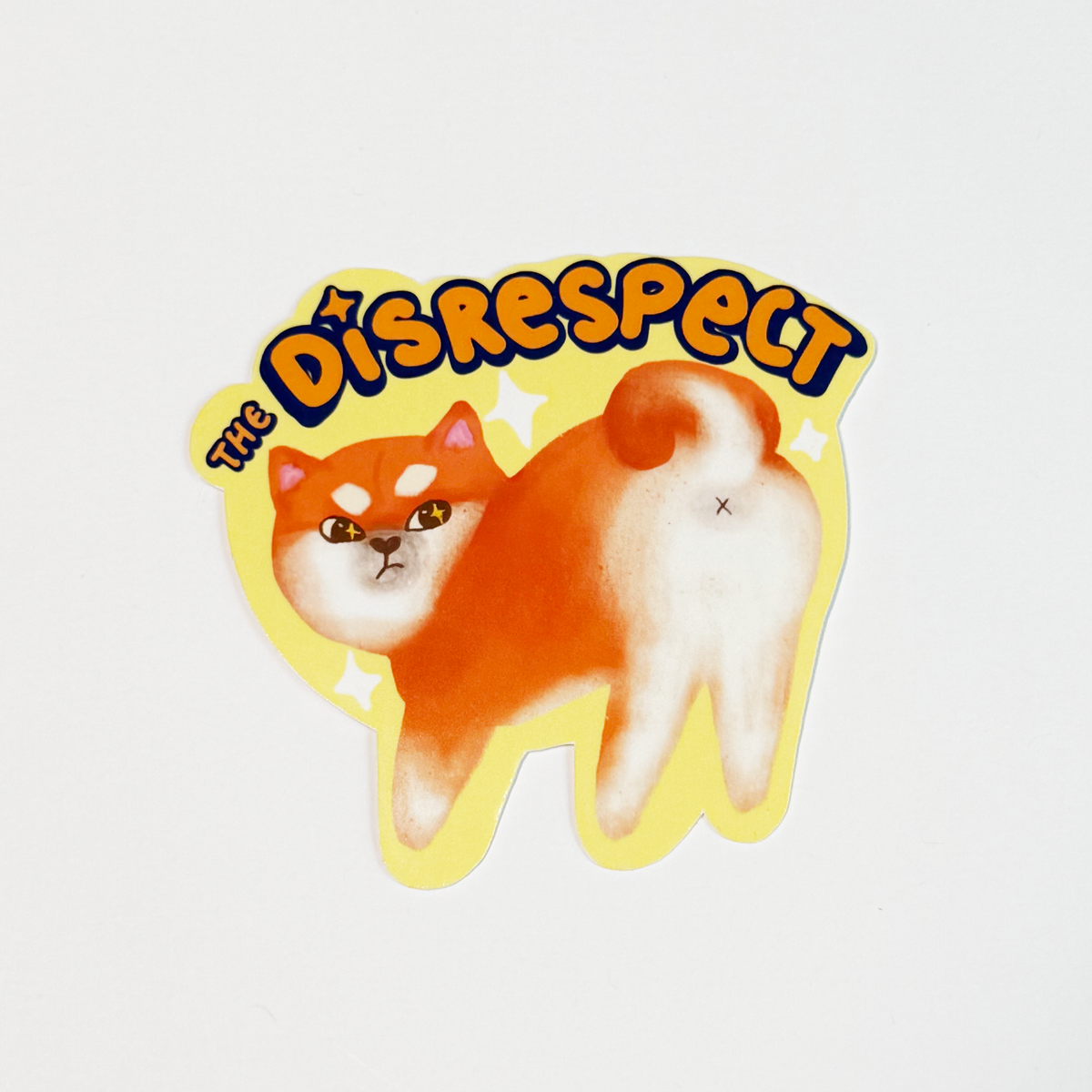 A die-cut sticker featuring an illustration of a Shiba Inu dog with its back turned, accompanied by the text 'THE DISRESPECT' in stylized lettering, shown on a plain white background.