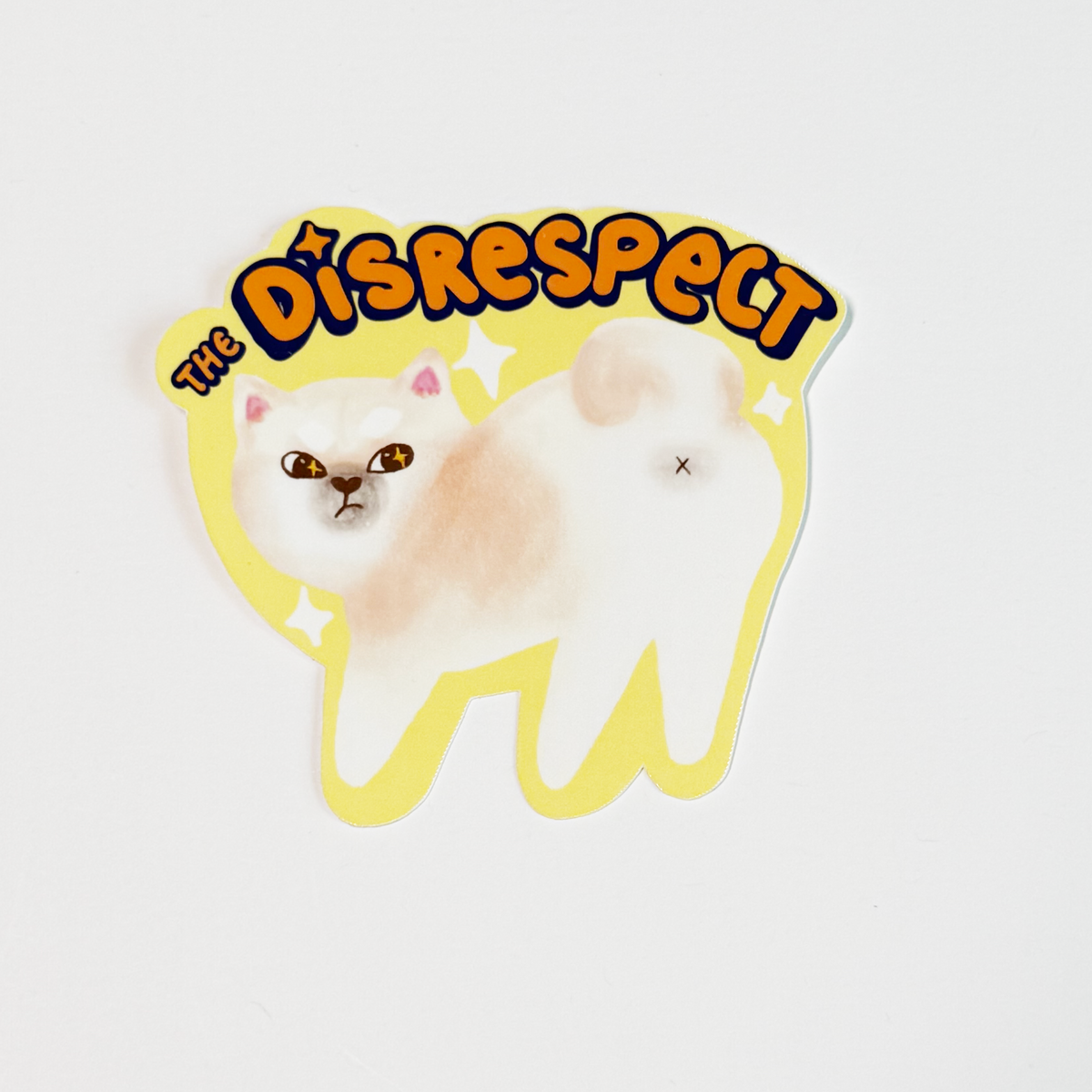 Cream Shiba sticking his butt out with the word the disrespect on top of him. It is a sticker in vibrant black orange and yellow color